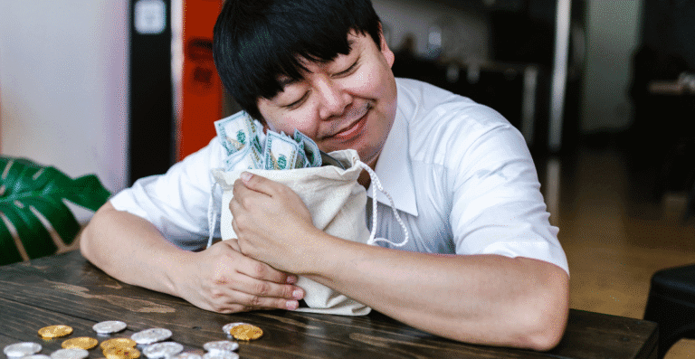 Um homem abraçado com um saco cheio de dinheiro